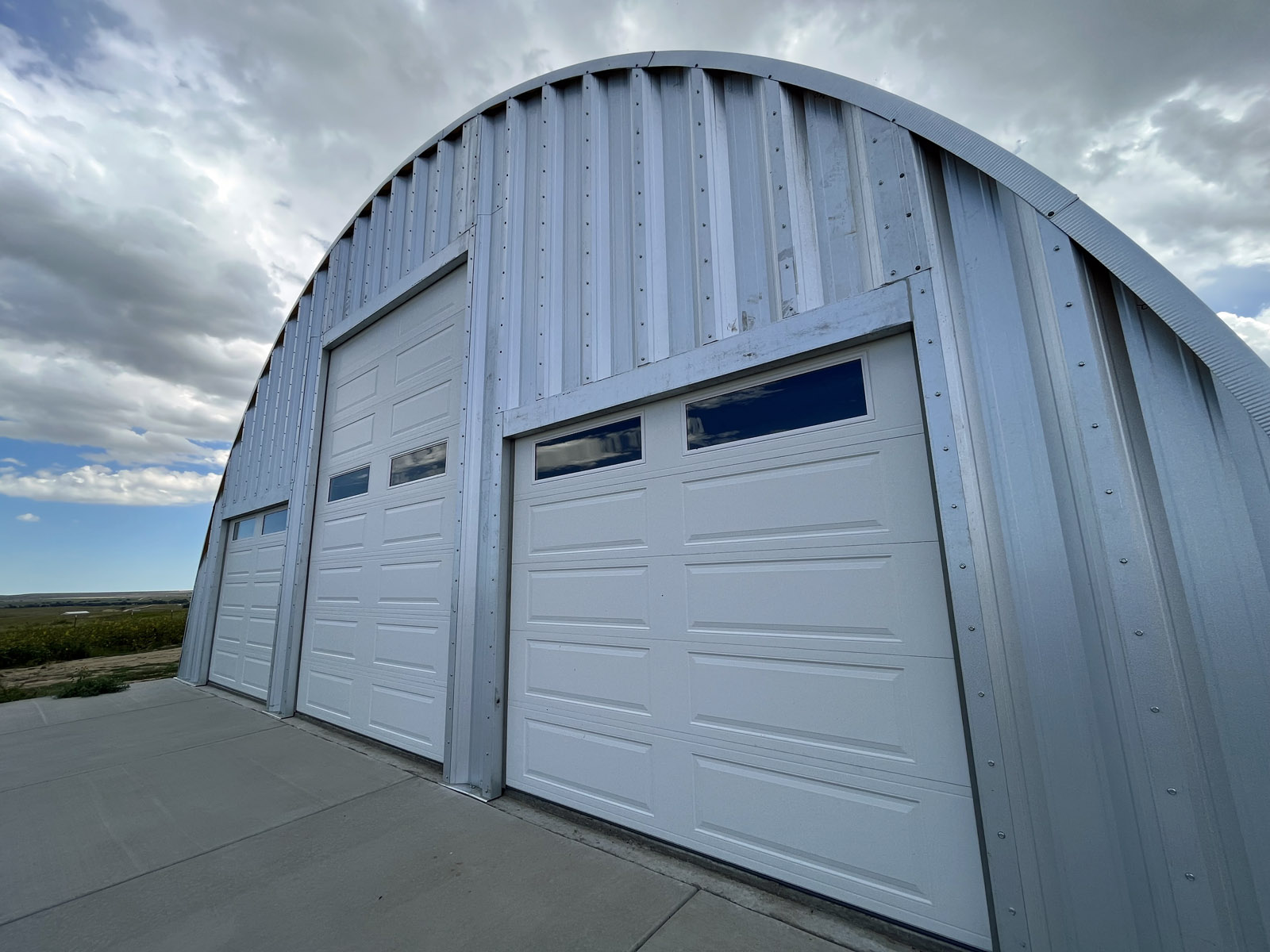 Arch building with three garage doors